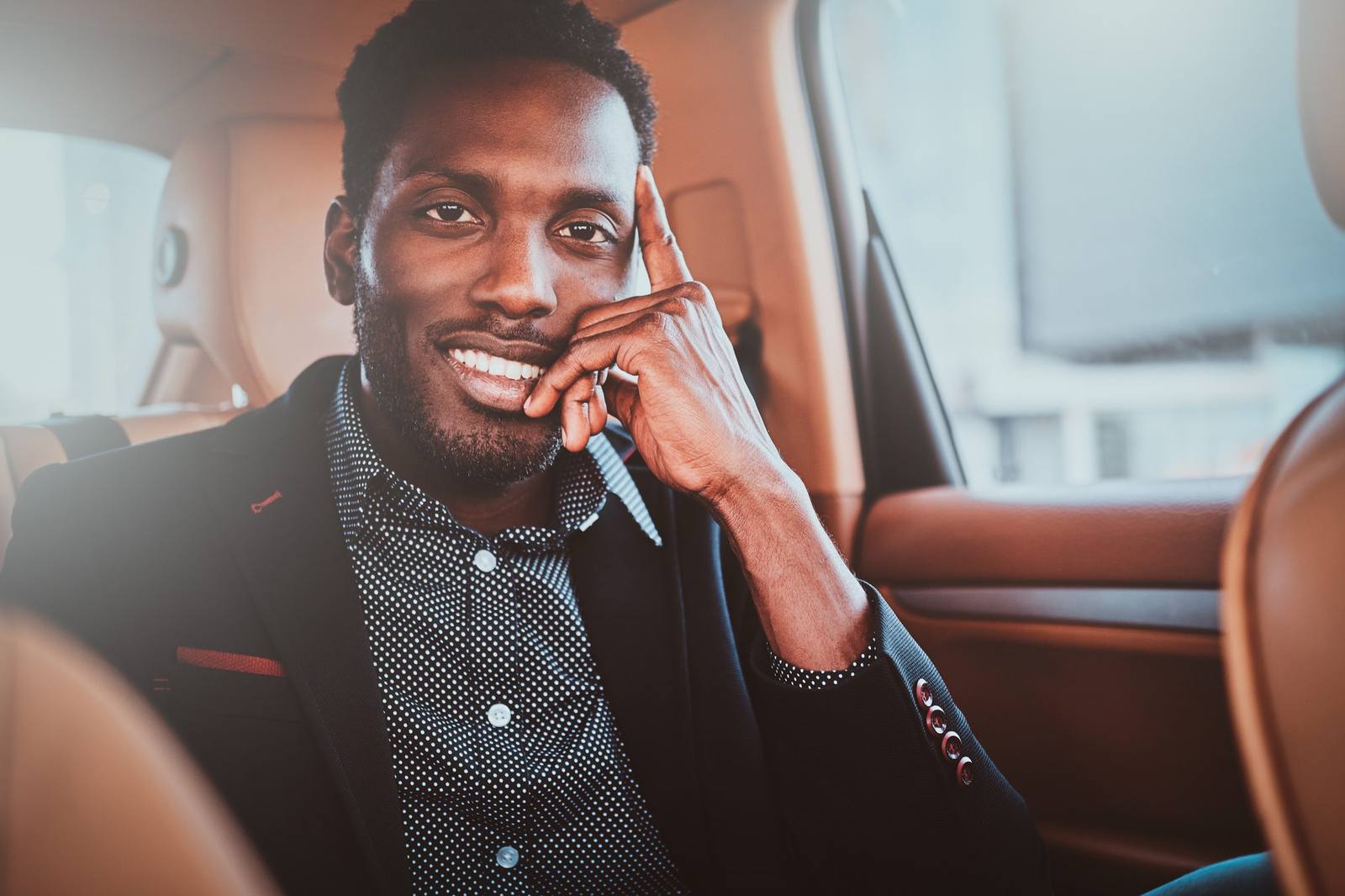 Smiling passenger in the back seat of a car