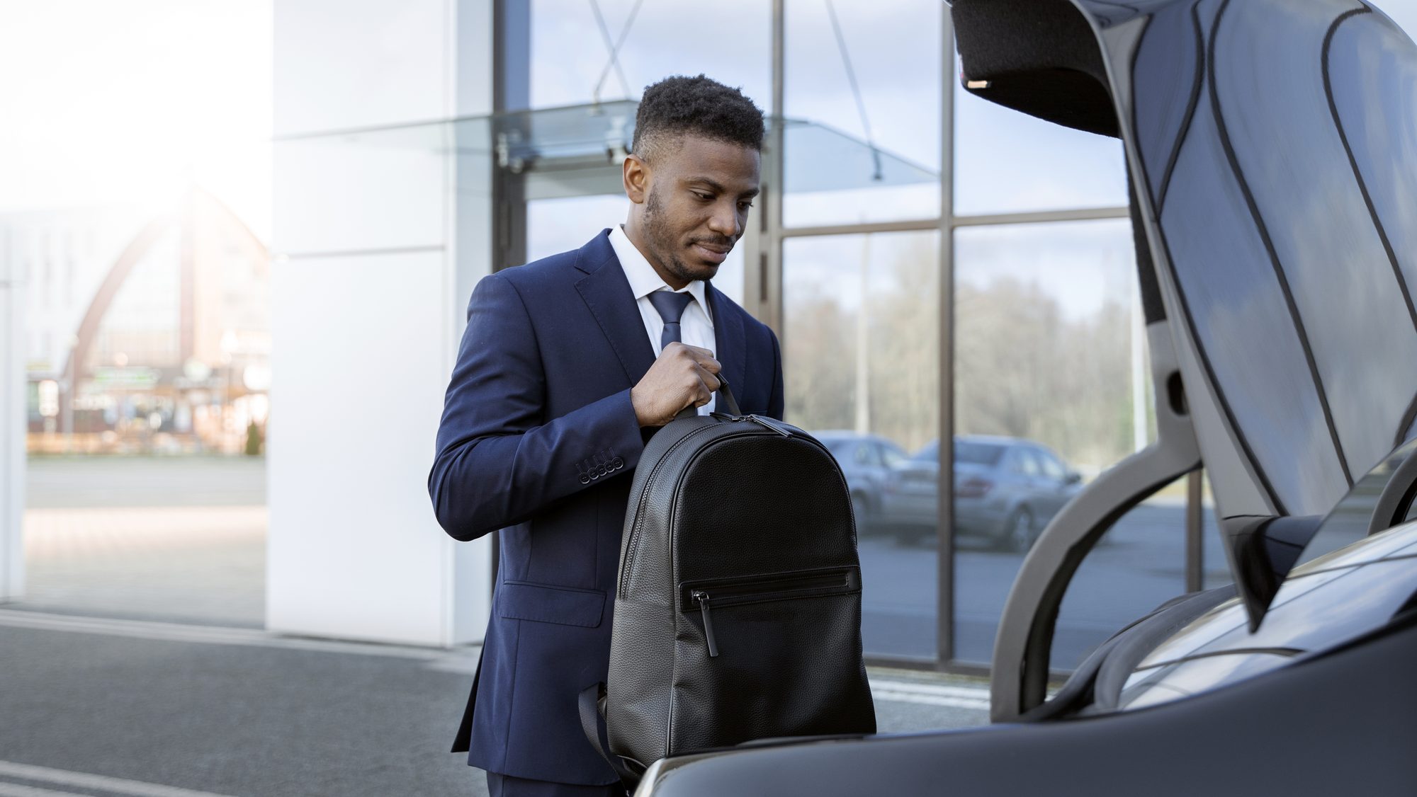 Chauffeur holding the car door open for a passenger